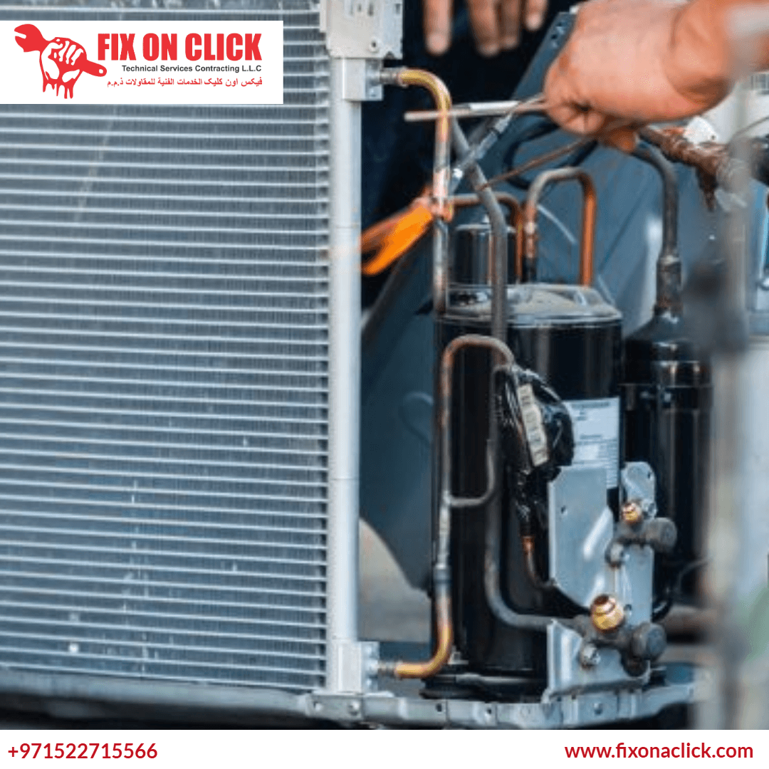 HVAC technician diagnosing AC compressor with pressure gauges in Dubai