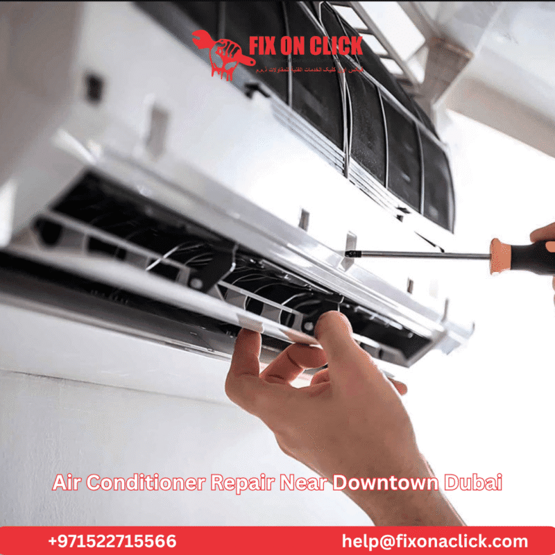 Fix on Click AC technician using a screwdriver to repair a wall-mounted air conditioner unit in a Downtown Dubai apartment