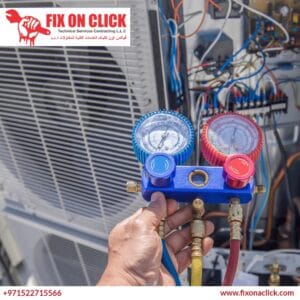 Fix on Click technician checking refrigerant pressure gauges during AC repair in Dubai Marina