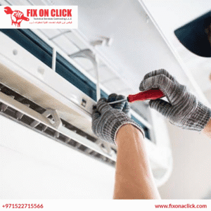Fix on Click technician inspecting salt-corroded outdoor AC unit at JBR Dubai tower