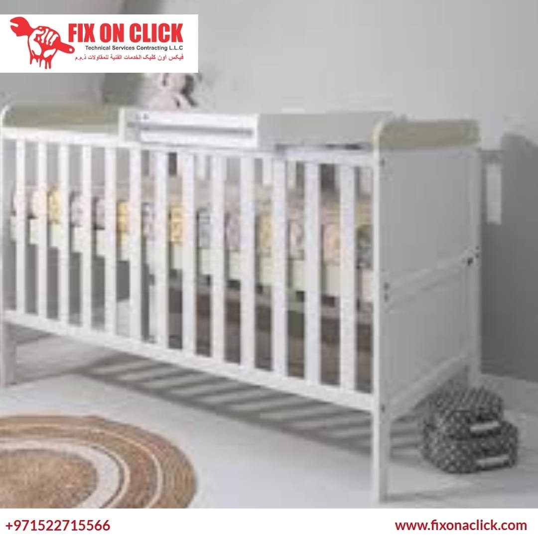 Carpenter making a baby cot safe and secure
