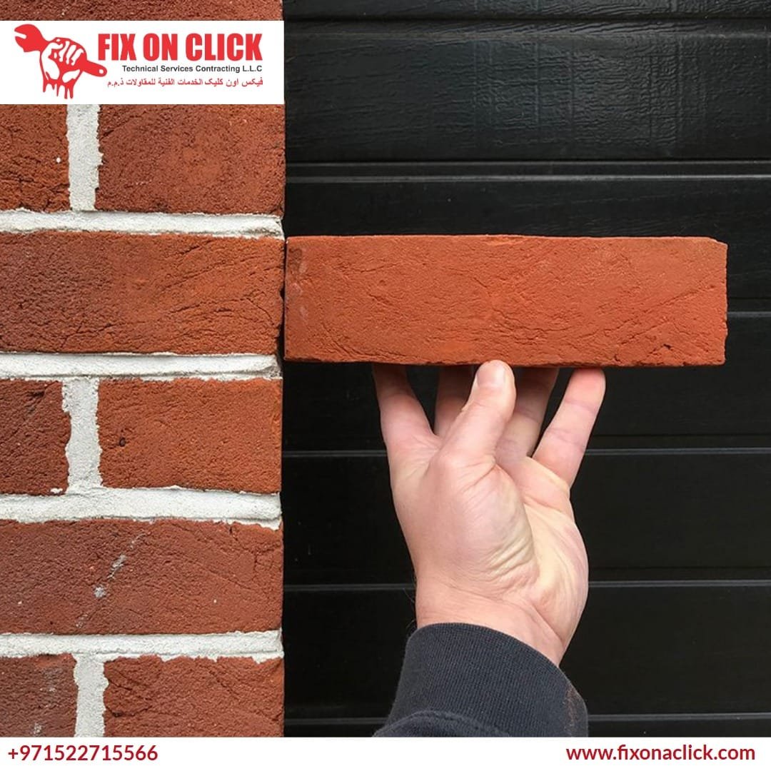 Expert mason carefully extracting a damaged brick