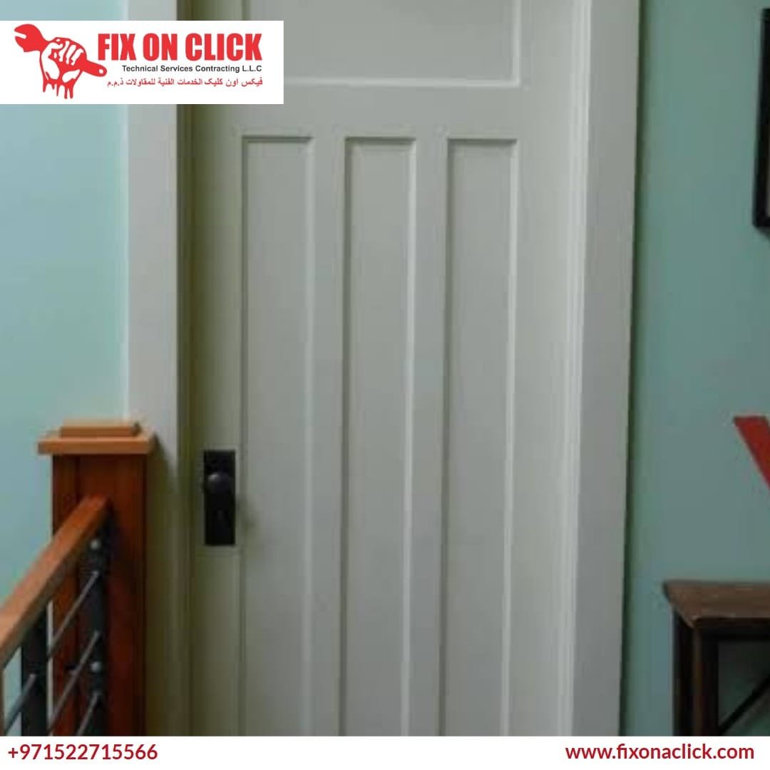 Expert carpenter trimming the bottom of a wooden door