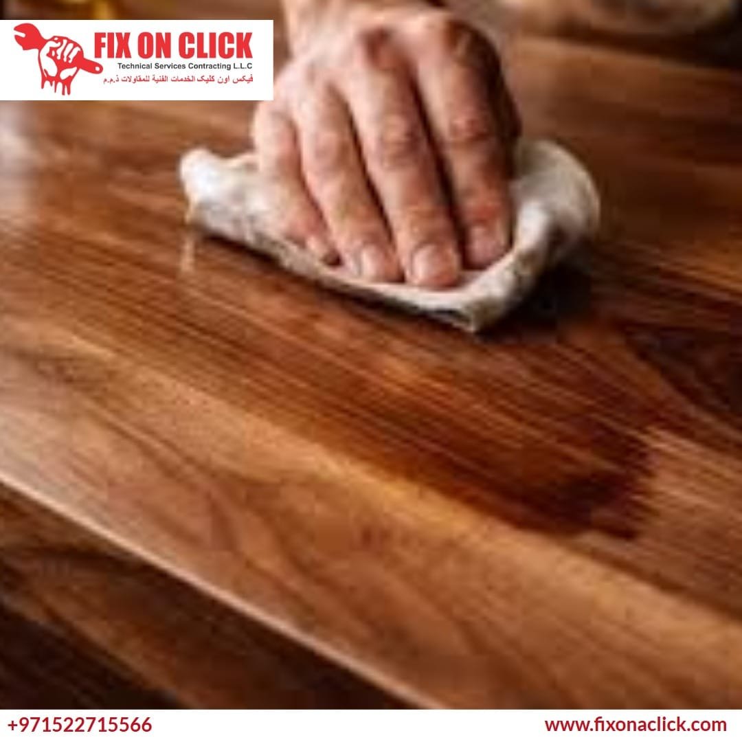 Expert applying finish to a wooden table