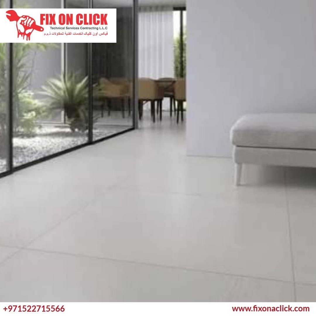 Professional tiler spreading adhesive for porcelain floor