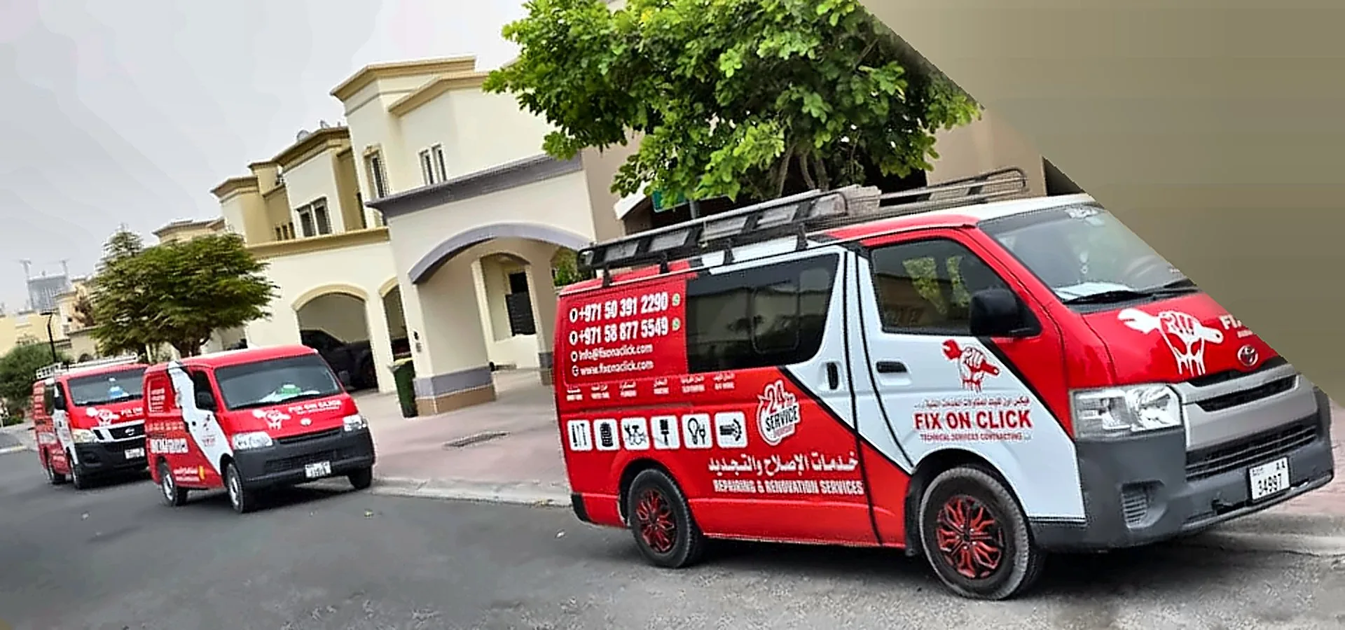 Fix On Click branded vans driving through a residential street in Dubai